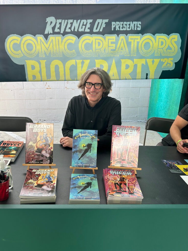 This is a happy me behind the table for a great signing block at Comic Creators Block Party ’25!